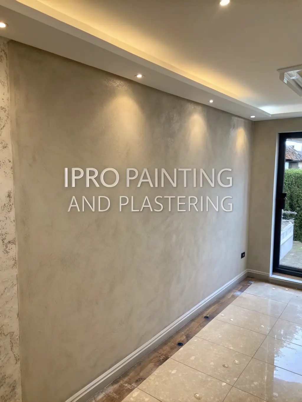 An image of a skilled plasterer applying a smooth finish to a wall, demonstrating the precision and expertise of Elysia's plastering services.